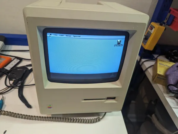 Classic Macintosh computer on the workbench.